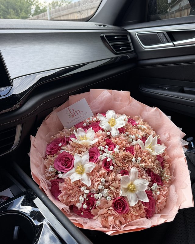 Baby's Cloud by Blooms x Mel — Hot pink roses woven through toffee carnations and baby's breath, with white tulips opened wide, in a blush wrap
