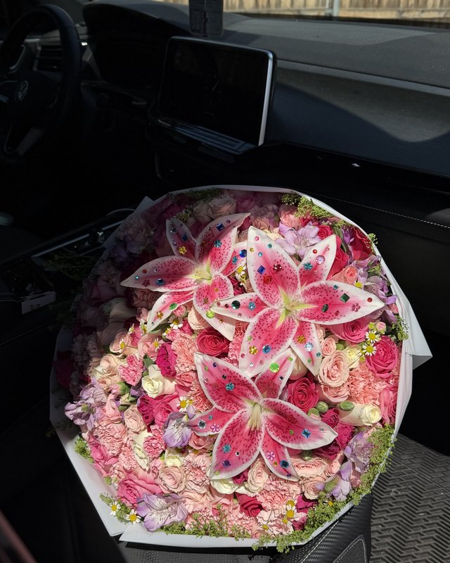 Bejeweled by Blooms x Mel — A hundred roses under jeweled stargazer lilies, packed with carnations, spray roses, chamomile, and lavender accents