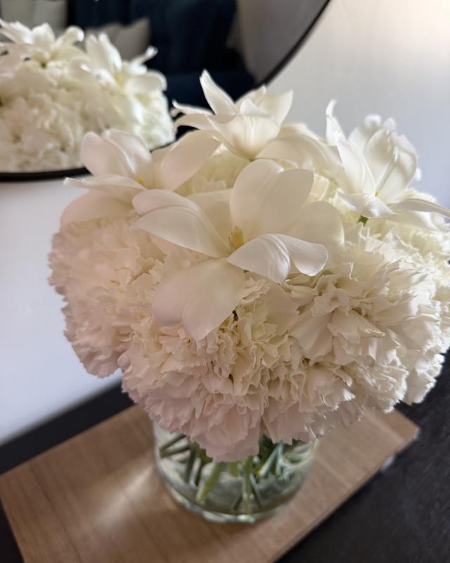 Blanco Puro by Blooms x Mel — All-white carnations and open tulips arranged in a glass vase