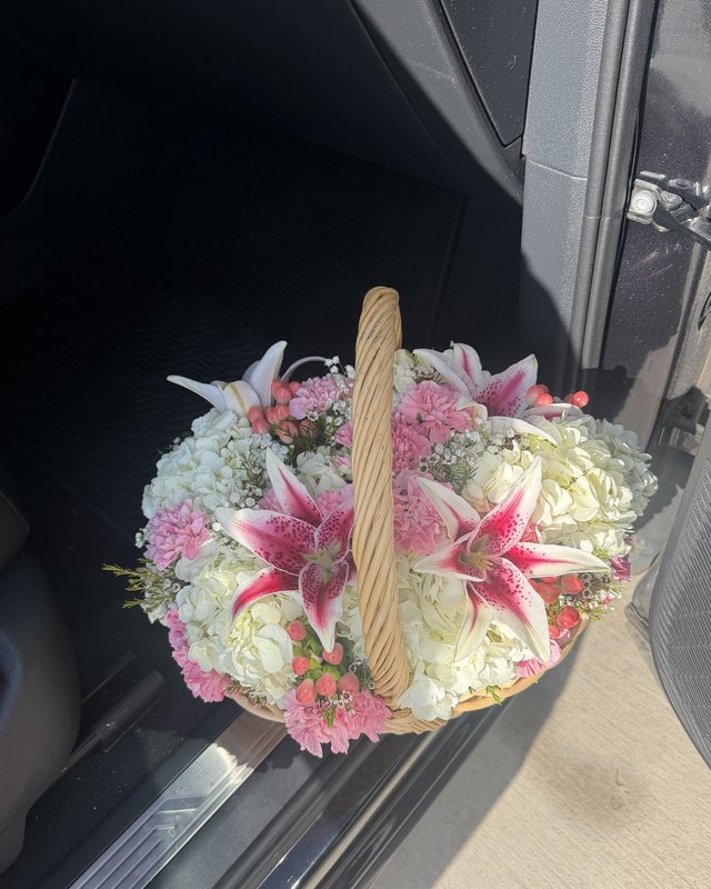 Canasta Estrella by Blooms x Mel — Stargazer lilies over white hydrangea with pink carnations, berries, and wax flower in a woven basket
