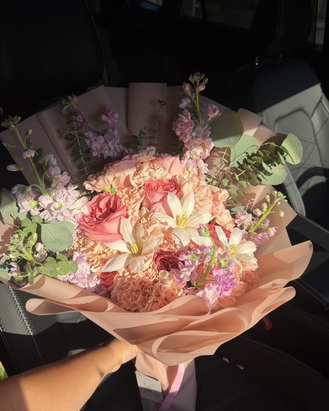 Durazno Dulce by Blooms x Mel — Peach carnations and garden roses with white tulips, lavender stock, and eucalyptus in a blush wrap