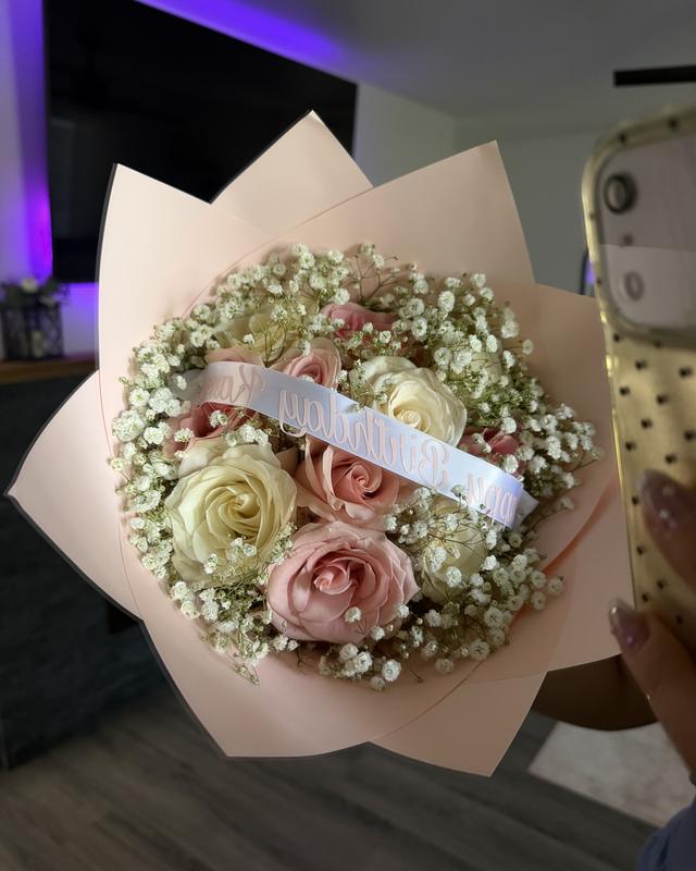 La Docena by Blooms x Mel — A sweet dozen roses with baby's breath in a petal wrap, ribbon message included