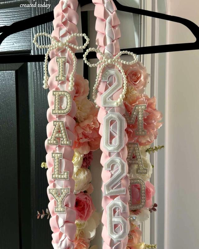 The Deluxe Lei by Blooms x Mel — Braided ribbon and flowers together with pearl bows, their name, and the year