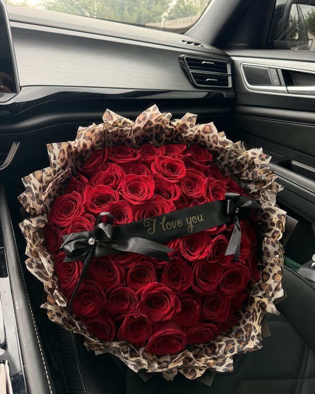 Wild Print Ramo by Blooms x Mel — Red roses wrapped in leopard print with a black satin ribbon